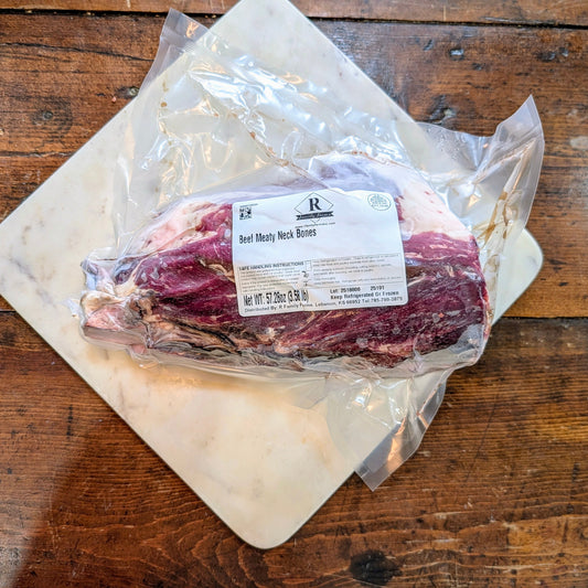 Packaged beef on a wooden surface with a visible label