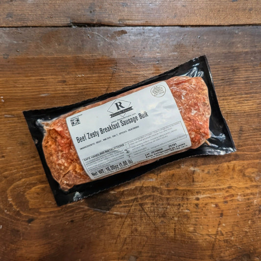 Packaged sausage on a wooden surface with a label