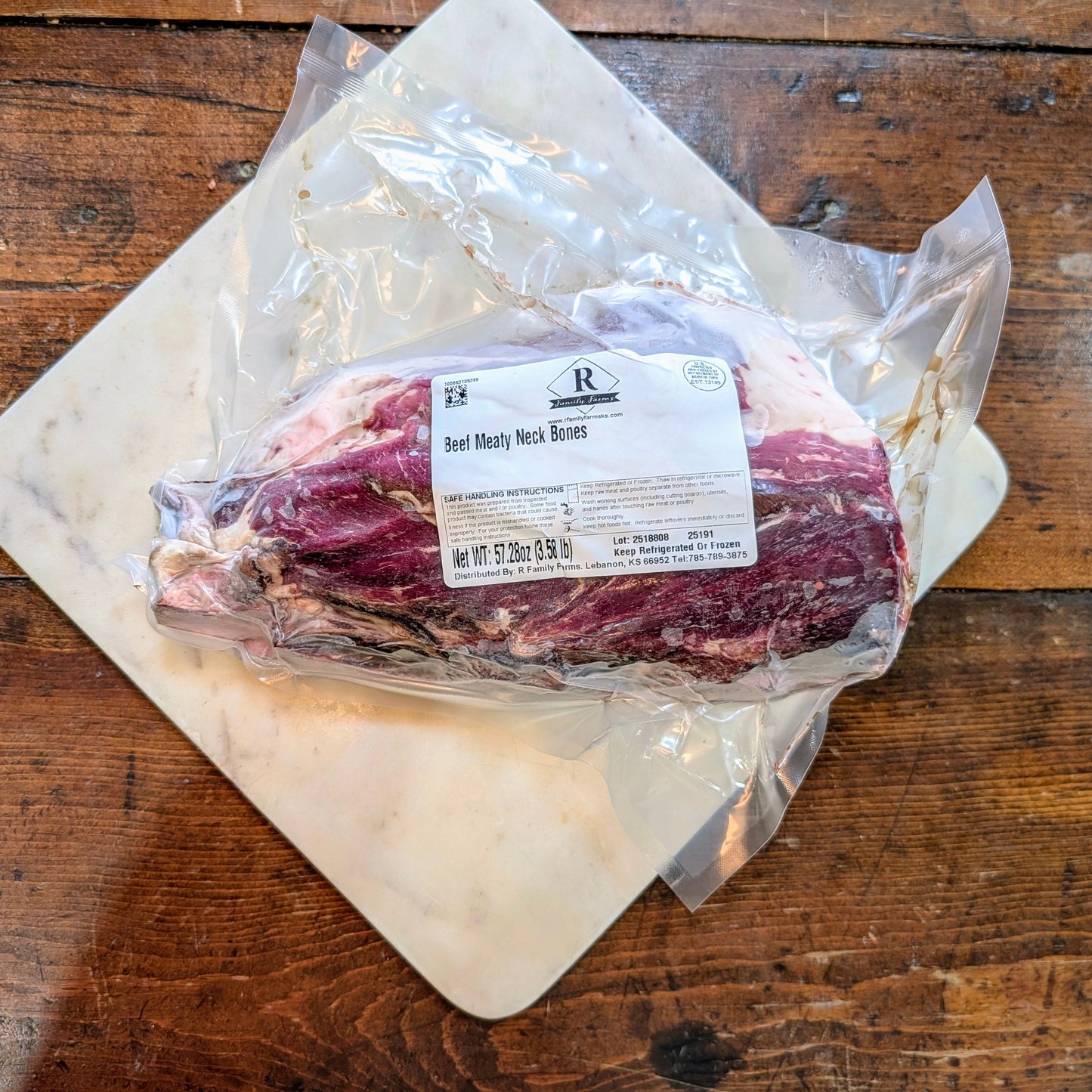 Packaged beef on a wooden surface with a visible label